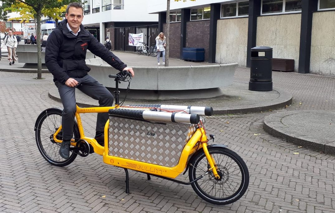 Tom Crone sitting on electric cargo bike